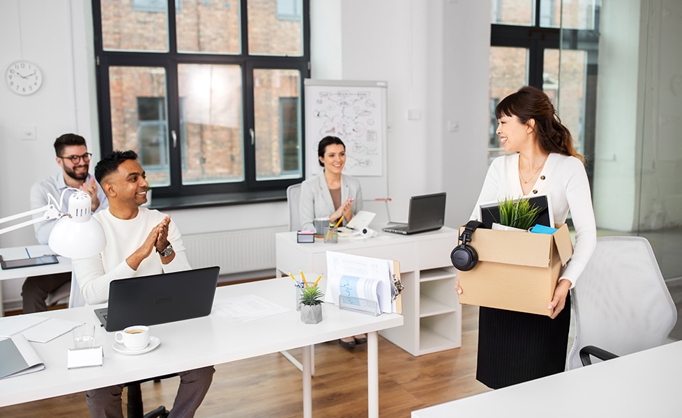 photo: woman carrying items out of office